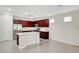 Modern kitchen with cherry cabinets, stainless steel appliances, and a center island with sink at 6190 Tillman Crest Ave, Las Vegas, NV 89139