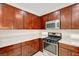 Modern kitchen featuring stainless steel appliances, sleek countertops, and dark wood cabinetry at 6190 Tillman Crest Ave, Las Vegas, NV 89139