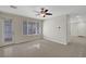 Bright living room with neutral walls, large window with blinds, and a ceiling fan with light at 6190 Tillman Crest Ave, Las Vegas, NV 89139