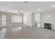 Open living room featuring tile floors, patio door, and a view of the front entry and stairs at 6190 Tillman Crest Ave, Las Vegas, NV 89139