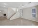 Bright living room featuring tile floors, a staircase, and views of a fireplace at 6190 Tillman Crest Ave, Las Vegas, NV 89139