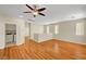 Bright and airy living room features wood floors, ceiling fan, and adjacent laundry room at 6190 Tillman Crest Ave, Las Vegas, NV 89139