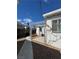 Covered back patio with aluminum frame, rock landscaping, and access to the yard at 621 S 9Th St, Las Vegas, NV 89101