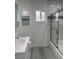 Clean bathroom featuring marble-style tile, a bathtub with glass door, and modern fixtures at 621 S 9Th St, Las Vegas, NV 89101