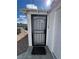 Close-up of the exterior of a screen door on a stucco building with visible hot tub at 621 S 9Th St, Las Vegas, NV 89101