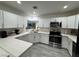 Modern kitchen featuring white cabinets, stainless steel appliances, and sleek countertops at 621 S 9Th St, Las Vegas, NV 89101