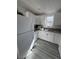 Kitchen featuring white cabinets, granite counters, stainless steel sink, and wood-look flooring at 621 S 9Th St, Las Vegas, NV 89101