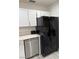 Well-lit kitchen with stainless steel dishwasher and a large black refrigerator at 621 S 9Th St, Las Vegas, NV 89101