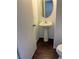 Cozy half bathroom featuring a pedestal sink, and dark wood grain floors at 6320 Tier Ave, Las Vegas, NV 89139