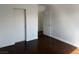 This bedroom features dark wood floors, white walls, and a closet at 6320 Tier Ave, Las Vegas, NV 89139