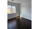 This bedroom features dark wood floors and a window with a view at 6320 Tier Ave, Las Vegas, NV 89139