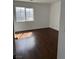 Bright bedroom with window allowing for natural light and hardwood floors at 6320 Tier Ave, Las Vegas, NV 89139