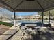 View of the community pool from under a gazebo with seating and a table for residents to gather and relax at 6320 Tier Ave, Las Vegas, NV 89139