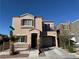 Two-story stucco home features a small balcony and an attached one car garage at 6320 Tier Ave, Las Vegas, NV 89139