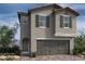 Charming two-story home featuring gray stucco, a two-car garage, and well-placed windows at 6598 Tumoulin St, Las Vegas, NV 89148