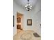 Spacious foyer with modern light fixture, artwork and doorway to home's other rooms at 6722 Desert Crimson St, Las Vegas, NV 89148