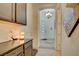 Hallway with dark cabinets, neutral walls and floors leads to the home's front entrance at 6722 Desert Crimson St, Las Vegas, NV 89148