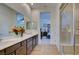 This bathroom features double sinks, a large mirror and a walk-in shower at 6722 Desert Crimson St, Las Vegas, NV 89148