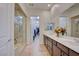 Luxurious bathroom with dual sinks, a large mirror, and access to a walk-in shower and closet at 6722 Desert Crimson St, Las Vegas, NV 89148