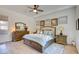 Inviting main bedroom featuring stylish furnishings, a ceiling fan, and hardwood flooring at 6722 Desert Crimson St, Las Vegas, NV 89148