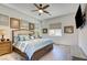 Comfortable main bedroom featuring a decorative ceiling fan and a large bed with elegant wooden flooring at 6722 Desert Crimson St, Las Vegas, NV 89148