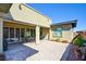 Covered patio with stone flooring, ample seating and view of manicured backyard at 6722 Desert Crimson St, Las Vegas, NV 89148