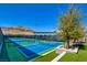 Community pickle ball courts with vibrant blue playing surfaces surrounded by lush landscaping at 6722 Desert Crimson St, Las Vegas, NV 89148