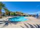 Community pool area features palm trees and a view of the nearby mountains at 6722 Desert Crimson St, Las Vegas, NV 89148