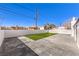 Spacious backyard featuring artificial turf area, concrete patio, and a privacy wall, ideal for relaxation and outdoor gatherings at 701 N Yale St, Las Vegas, NV 89107