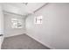 A bright bedroom featuring a large window, neutral carpet, and fresh white paint at 701 N Yale St, Las Vegas, NV 89107