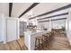 Open floor plan kitchen featuring stainless appliances, kitchen island, and modern wood beam accents at 701 N Yale St, Las Vegas, NV 89107