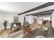 Staged living room with beamed ceilings leads to the kitchen and dining area at 701 N Yale St, Las Vegas, NV 89107