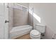 Bathroom featuring a tiled shower-tub combo with a large window at 7505 Crystal Clear Ave, Las Vegas, NV 89113