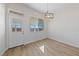 Bright dining area features wood flooring, a stylish light fixture, and a glass panel back door at 7505 Crystal Clear Ave, Las Vegas, NV 89113