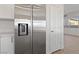 Side by side refrigerator in the kitchen, view to adjacent dining and living area at 7505 Crystal Clear Ave, Las Vegas, NV 89113