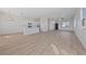 Open-concept living space featuring light hardwood floors, a kitchen island, and lots of natural light at 7505 Crystal Clear Ave, Las Vegas, NV 89113