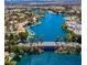 Beautiful aerial view of lake community with bridge and lush green trees at 7632 Desert Largo Ave, Las Vegas, NV 89128