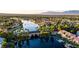 Aerial view of lakeside community featuring bridges, lush landscaping, and palm trees at 7632 Desert Largo Ave, Las Vegas, NV 89128