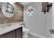 Stylish half bathroom features a modern sink, decorative mirror, and unique diamond shaped window at 7632 Desert Largo Ave, Las Vegas, NV 89128