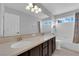 Bright bathroom with dual sinks, ample counter space, and natural light from multiple windows at 7632 Desert Largo Ave, Las Vegas, NV 89128