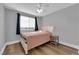 Serene bedroom with hardwood floors, a ceiling fan, and a neutral color palette for relaxation at 7632 Desert Largo Ave, Las Vegas, NV 89128