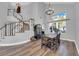 Elegant dining area with soaring ceilings, staircase and wood laminate flooring at 7632 Desert Largo Ave, Las Vegas, NV 89128