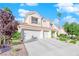 Charming two-story home with a three-car garage and a lush landscaped yard at 7632 Desert Largo Ave, Las Vegas, NV 89128