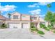 Charming two-story home with a three-car garage and a beautiful green lawn at 7632 Desert Largo Ave, Las Vegas, NV 89128