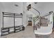 Inviting foyer with coat rack and a gracefully curved staircase at 7632 Desert Largo Ave, Las Vegas, NV 89128