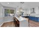 Open kitchen featuring an island, pendant lighting, stainless appliances, and wood laminate flooring at 7632 Desert Largo Ave, Las Vegas, NV 89128