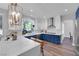 Modern kitchen featuring a center island with seating, a large window and stainless steel appliances at 7632 Desert Largo Ave, Las Vegas, NV 89128