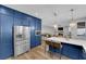 Charming kitchen island, pendant lights, and stainless steel refrigerator lead into the living room at 7632 Desert Largo Ave, Las Vegas, NV 89128