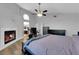 Another view of the main bedroom featuring a fireplace, desk, and a peloton at 7632 Desert Largo Ave, Las Vegas, NV 89128