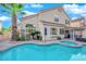 Beautiful backyard pool and patio, surrounded by lush landscaping, ideal for relaxation and leisure at 7632 Desert Largo Ave, Las Vegas, NV 89128